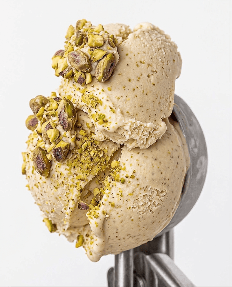 Pistachio ice cream scoop with chopped pistachios